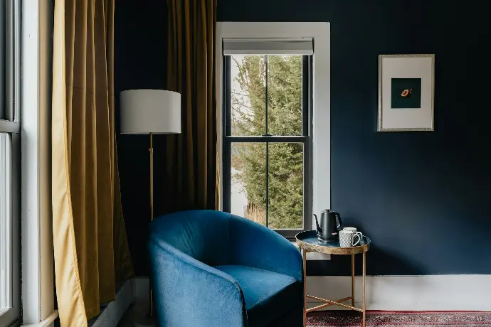 a blue chair sitting in front of a window