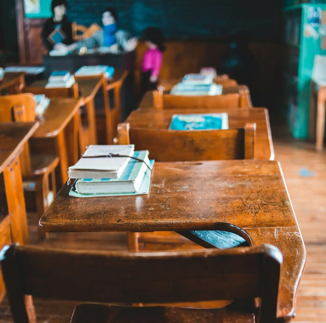 brown wooden table with books on top